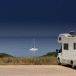 RV Parked at the Water Under The Stars