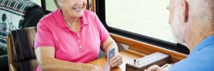 Man and Woman playing card games on Rv road trip